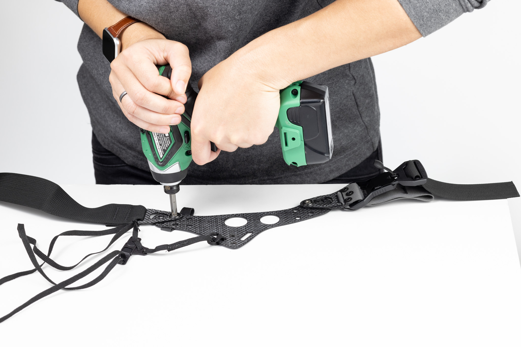 Photo of using a power driver to tighten Enigma screws.