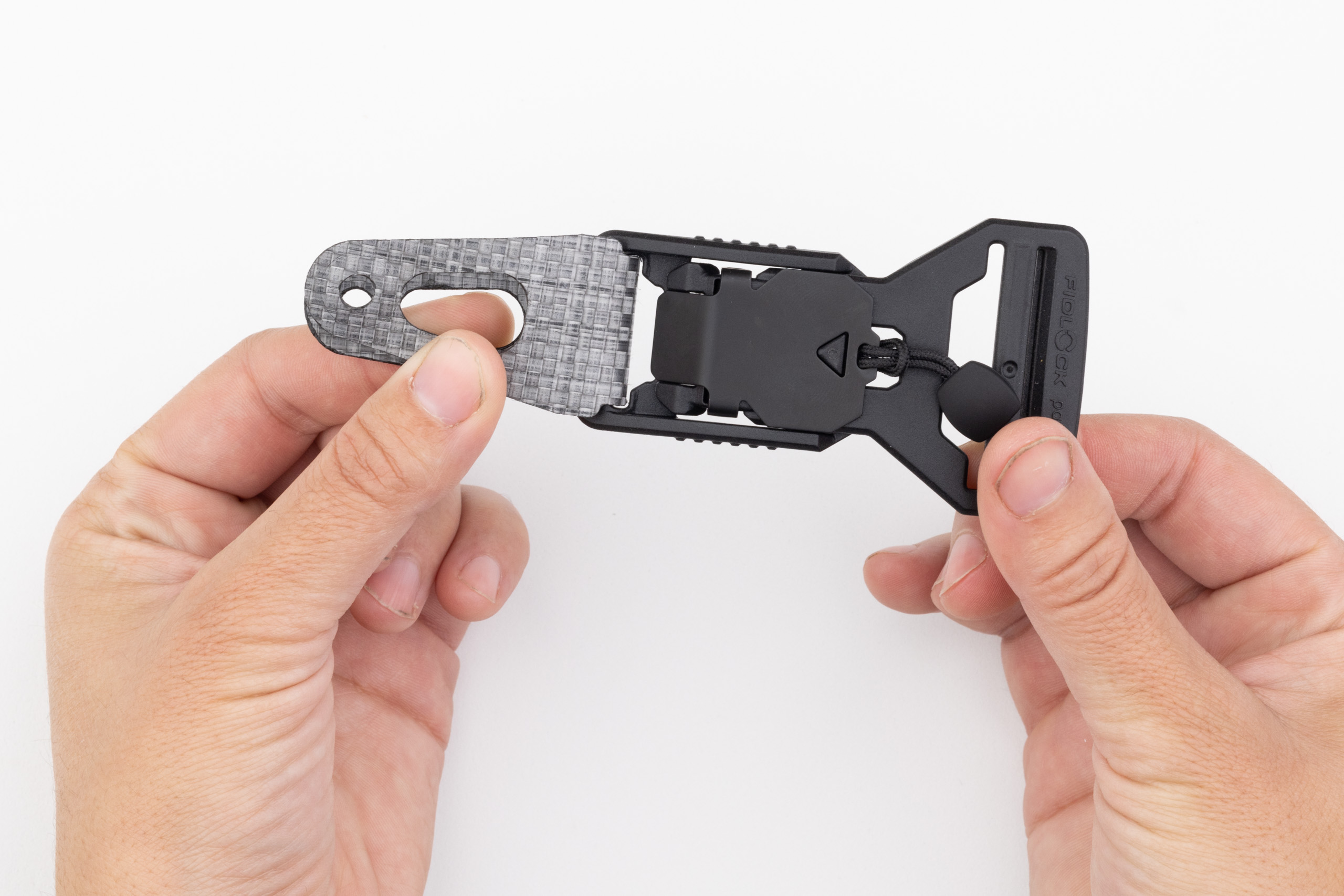 Photo of inserting Enigma tab into buckle.