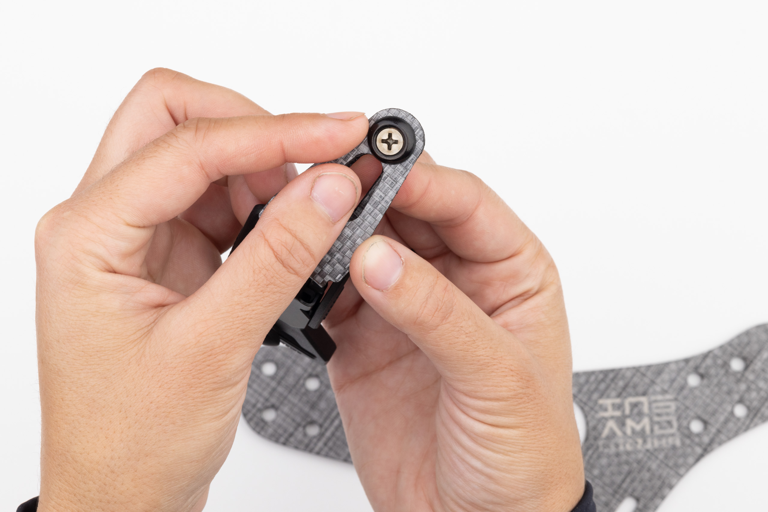 Photo of screw placed through finish washer and belt end.