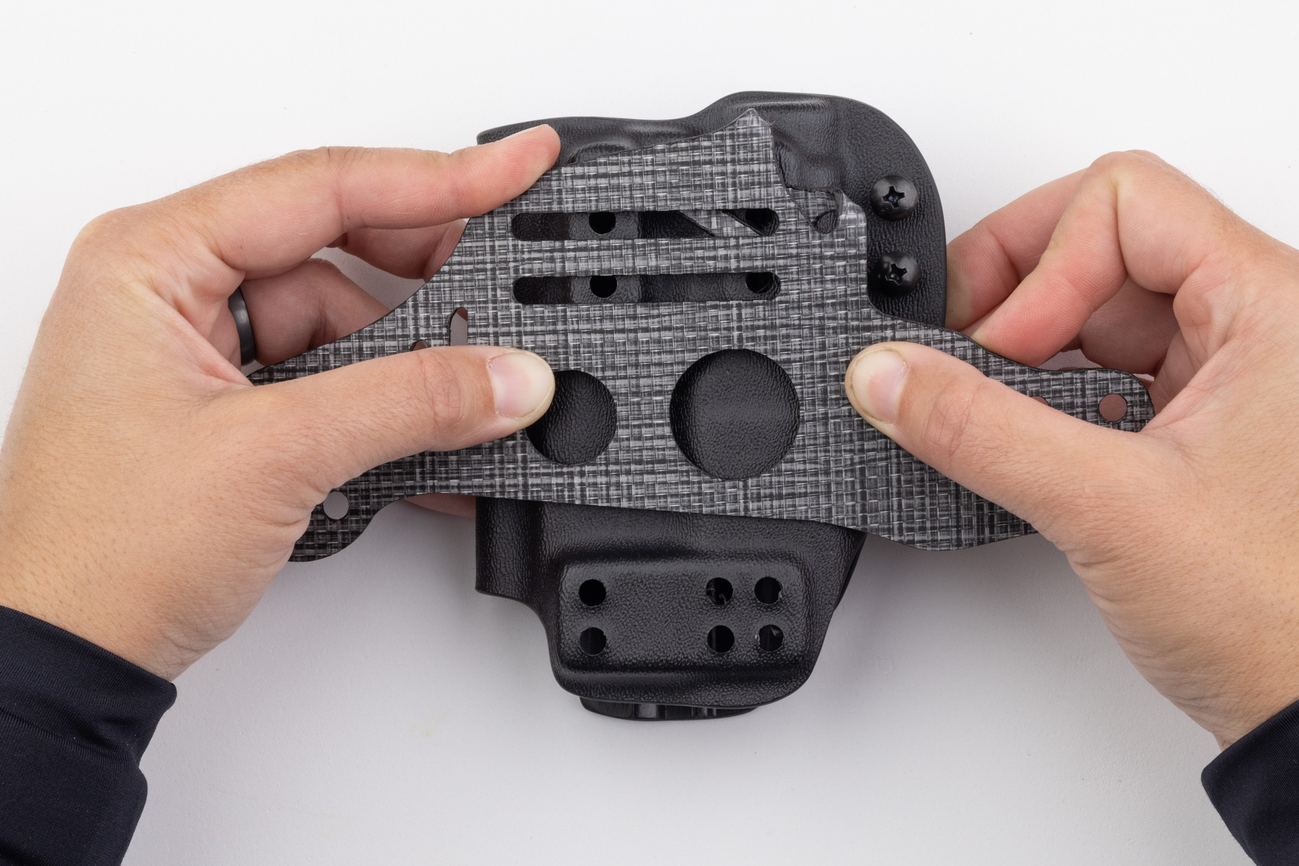 Photo showing how folded leg leash tab on Gen 1 Enigma doesn't hang down below the holster.