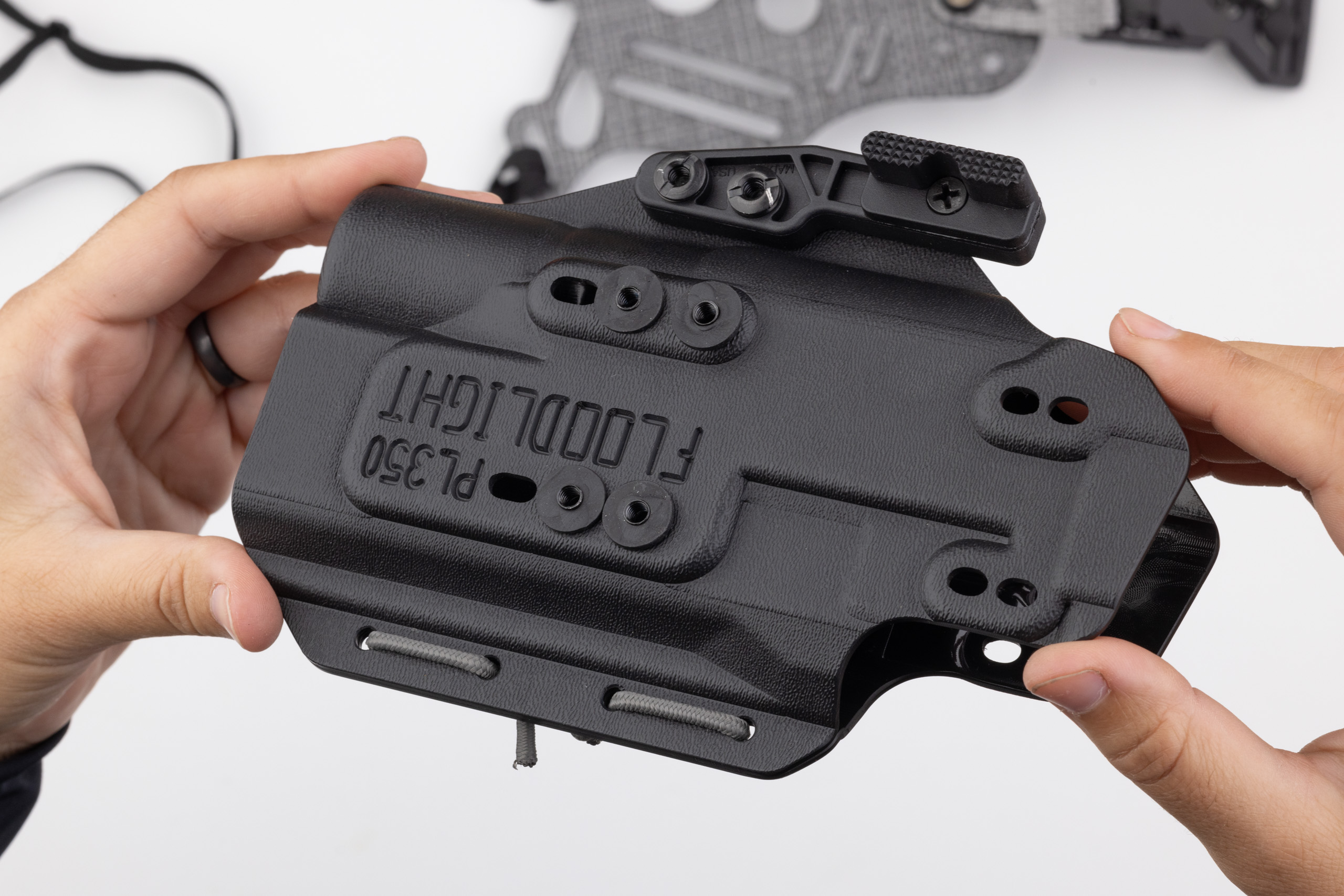 Photo of screw posts and rubber washers installed on kydex holster.