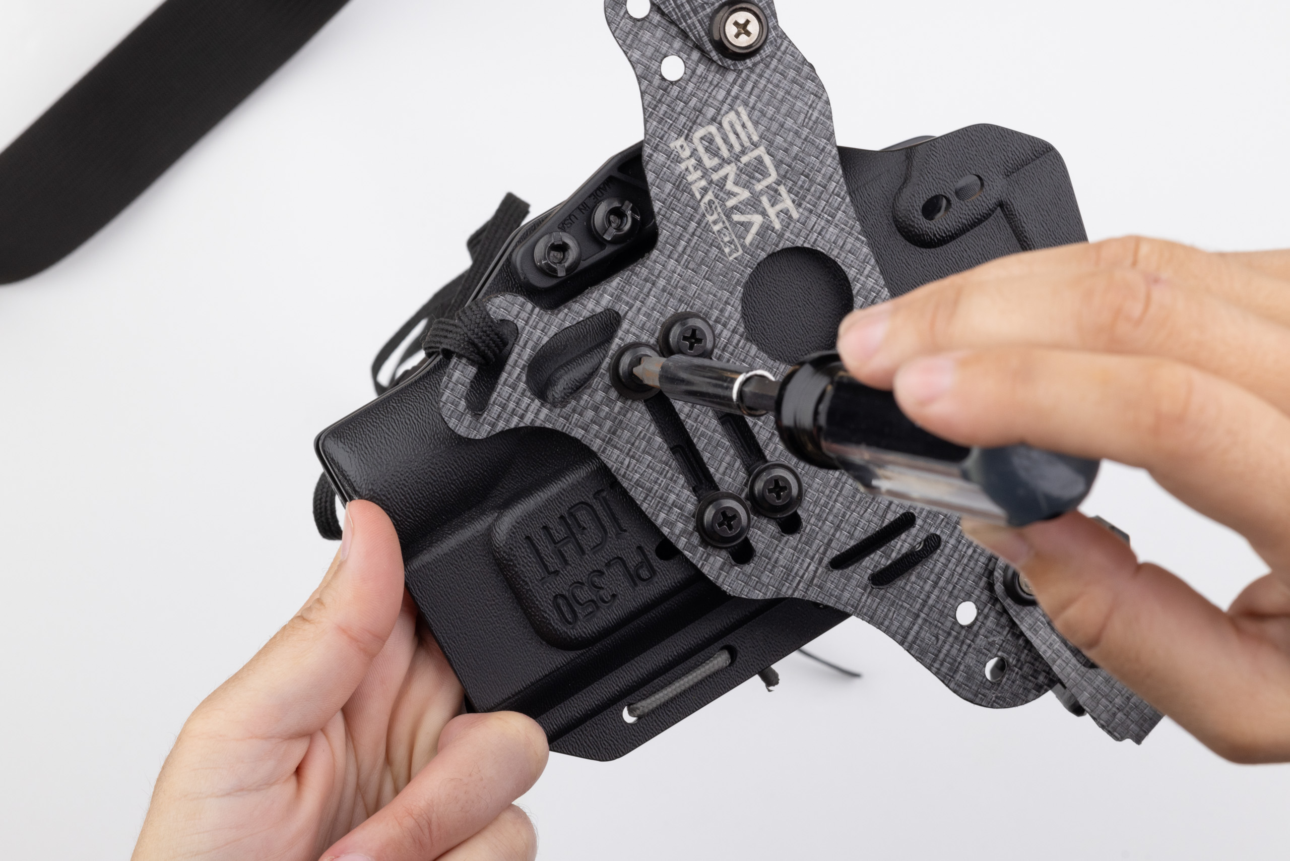 Photo of all four screws installed attaching holster to Enigma faceplate.