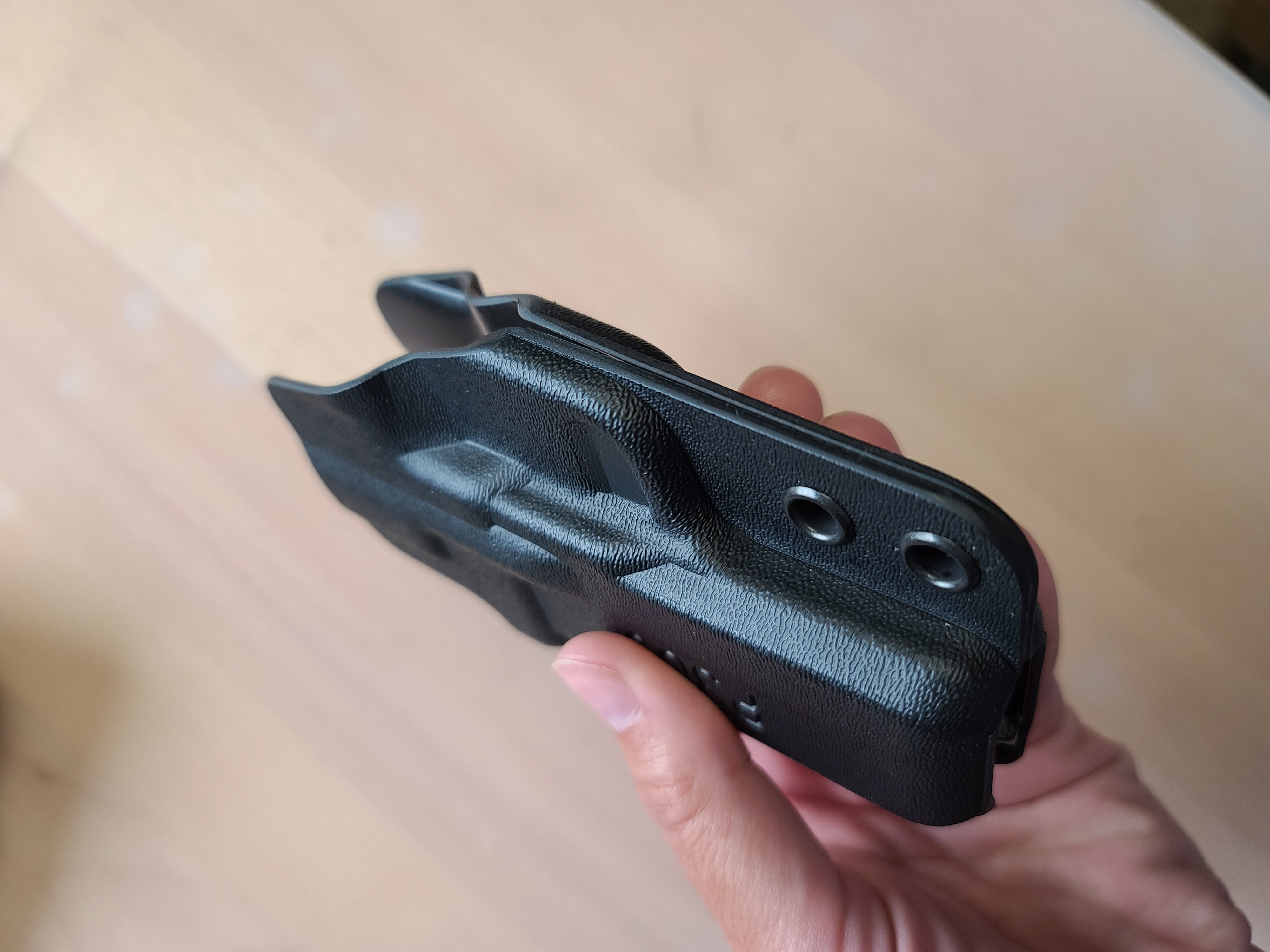 Photo of fixed retention kydex holster, from an angle.