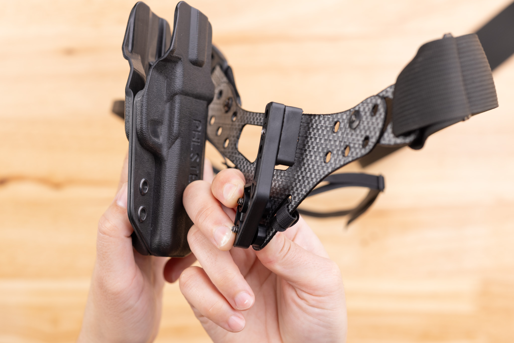 Photo of kydex holster and Modwing being installed on Enigma faceplate.