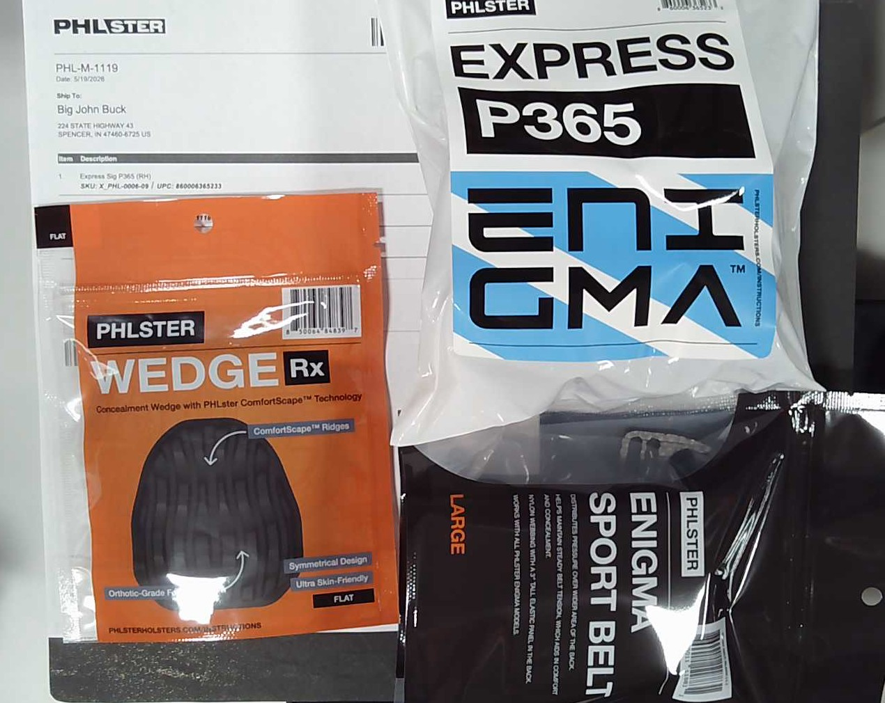 A PHLster Express P365 holster package, Wedge Rx, and Enigma Sport Belt staged with the customer's packing slip — the moment an order ships out